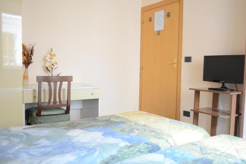 a bedroom with a bed and a desk and a television at Cantina Dell'Arte in Ascoli Piceno