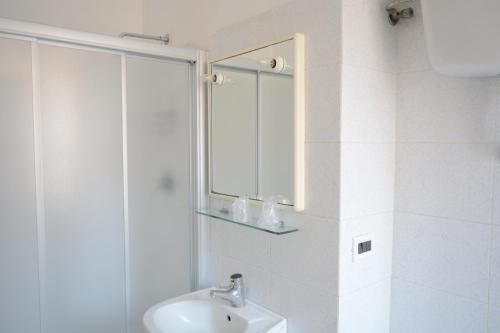 a bathroom with a shower and a sink and a mirror at Cantina Dell'Arte in Ascoli Piceno