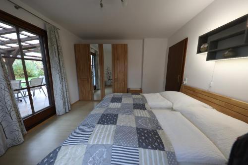 a bedroom with two beds and a large window at Gästehaus Reingruber in Ried im Traunkreis