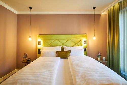 a bedroom with two beds with white pillows at Classic Hotel Harmonie in Cologne