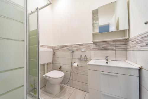 La salle de bains est pourvue de toilettes, d'un lavabo et d'une douche. dans l'établissement Naranji House Blue - Relax, à Altavilla Milicia