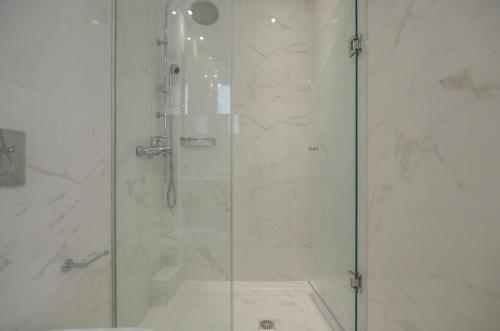 a bathroom with a shower with a glass door at Ilion Hotel in Naxos Chora