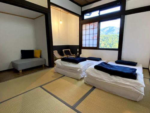 Säng eller sängar i ett rum på Guesthouse Nedoko