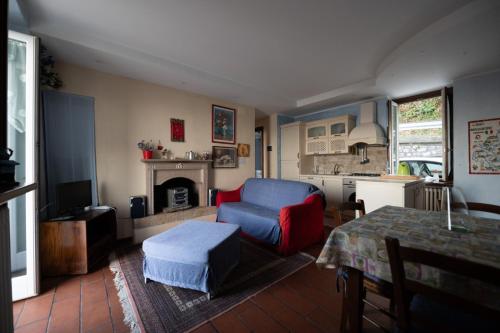 un soggiorno con una sedia blu e un camino di Appartamento VillaGiò - Terrazzo a Stresa