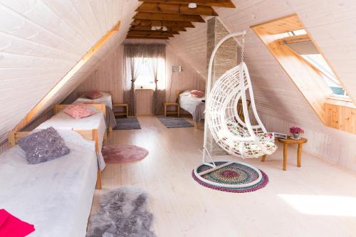 a attic room with two beds and a swing at Mere kodumajutus in Kärdla