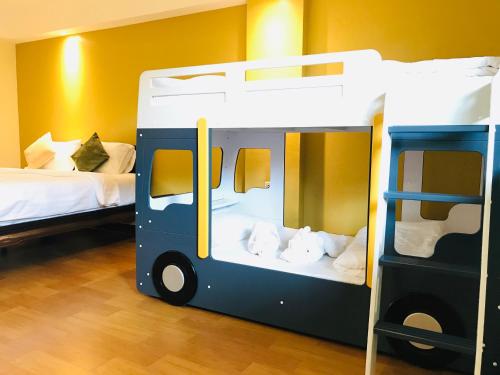 a bunk bed in a room with two beds at Baan Sang Singh in Chiang Mai