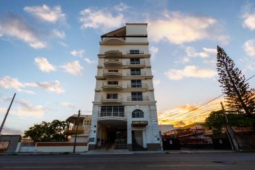 a tall white building with a lot of windows at Hotel Maria del Rocio in Veracruz