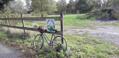 a bike parked next to a fence on a road at au fabuleux festin in La Possonnière