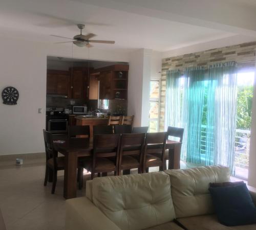 a living room with a couch and a table and chairs at Luxury in the Caribbean in Sosúa