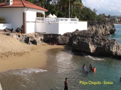 a group of people in the water at a beach at Luxury in the Caribbean in Sosúa