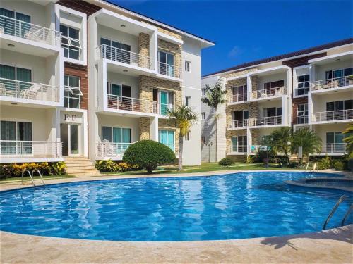 a swimming pool in front of two apartment buildings at Luxury in the Caribbean in Sosúa