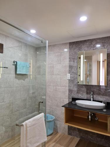 a bathroom with a sink and a mirror at Royale Suites by Arc Royal Luxury Apts in Anse Royale