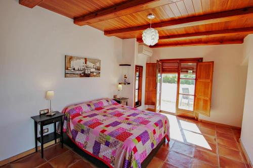 a bedroom with a bed and a wooden ceiling at Finca Argudo - private pool villa in Moraira in Moraira