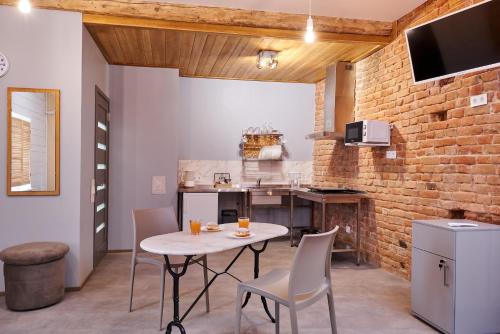 a kitchen with a table and chairs in a room at New Historical Museum Apartment in Kharkiv
