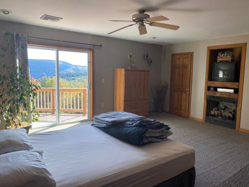 a bedroom with a large bed and a balcony at Mountain house in Palmerton
