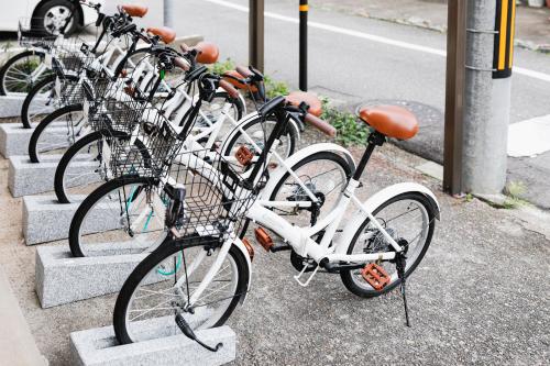 a row of bikes parked next to a street at hiyohiyo in Kanazawa