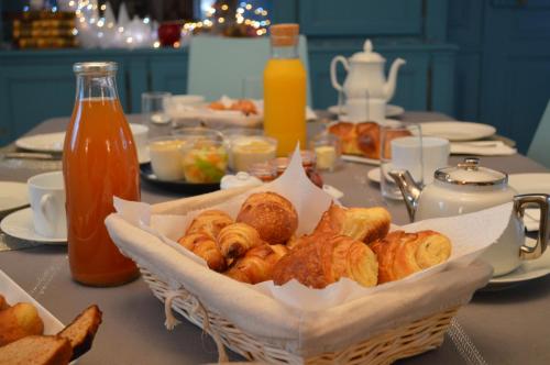 a basket of croissants and other pastries on a table at Manoir de Beaupré in Vannes