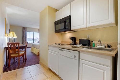 a kitchen with a sink and a table in a room at LikeHome Extended Stay Hotel Warner Robins in Warner Robins
