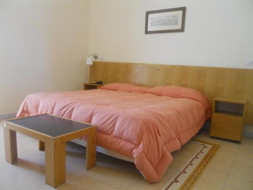 Ένα ή περισσότερα κρεβάτια σε δωμάτιο στο Albergo Santa Teresa