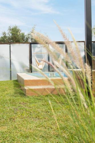 a view of a swimming pool from the grass at La Finca de Vane in Valle de Guadalupe