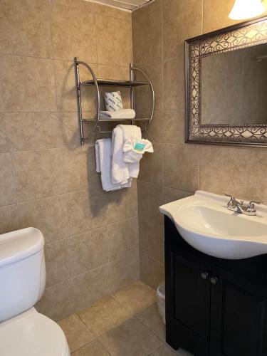 a bathroom with a sink and a toilet and a mirror at The Atlantic in Myrtle Beach