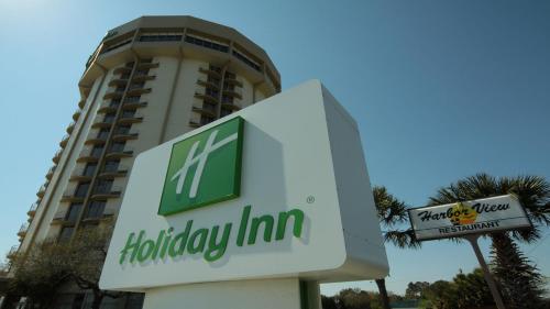 a sign in front of a holiday inn hotel at Holiday Inn Charleston-Riverview by IHG in Charleston