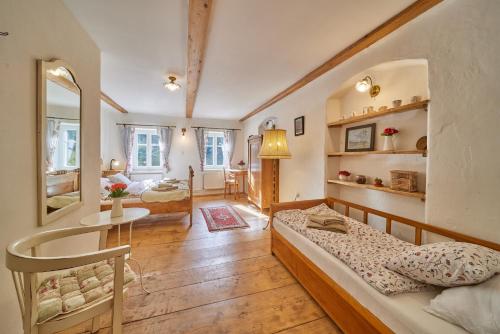 a bedroom with a bed and a living room at POD SVATOU ANNOU - penzion a řízkovna in Horní Maršov
