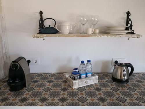 a kitchen counter with bottles of water on a tile floor at Snug Houseguests in Lisbon