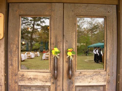 a wooden door with two windows with flowers on it at Minami Aso Luna Observatory Auberge Mori no Atelier in Minami Aso