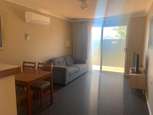 a living room with a couch and a table at Waratah in Albany