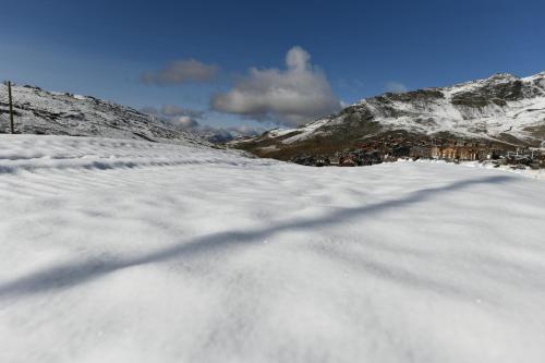 a shadow of a person on a snow covered mountain at Val Thorens Temple of the Sun - ski in, ski out in Val Thorens