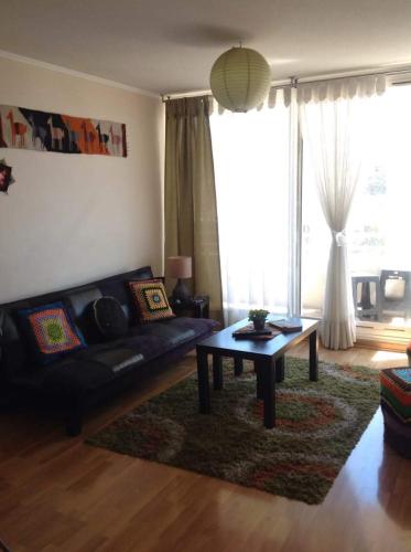 a living room with a couch and a coffee table at Departamento vista al mar in Valparaíso