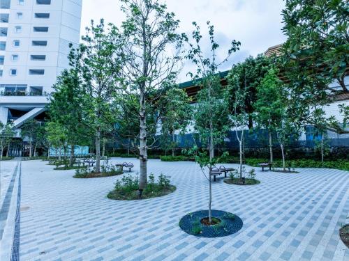 a park with trees and benches in front of a building at APA Hotel & Resort Ryogoku Eki Tower in Tokyo