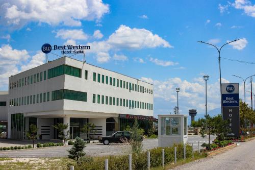 a building with a car parked in front of it at Best Western Hotel Galla in Pristina