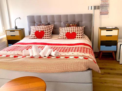 a bedroom with a bed with red and white pillows at House of Harmony in Stäfa