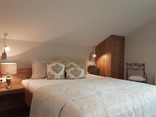 a bedroom with a large white bed with pillows at Gästehaus Pfister Maria in Hippach