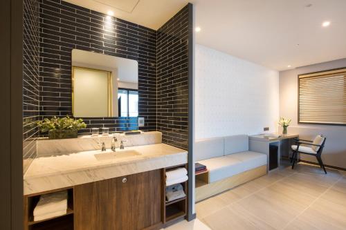 a bathroom with a sink and a mirror at Nampo Hound Hotel Premier in Busan