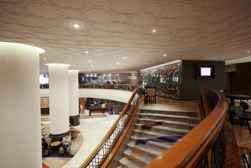 a spiral staircase in a shopping mall at Narai Hotel in Bangkok
