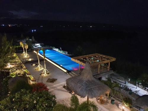 an overhead view of a swimming pool at night at Padadita Beach Hotel in Waingapu