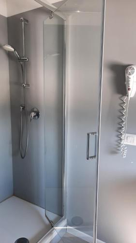 a shower with a glass door in a bathroom at Bergamo GuestHouse - Self Check-in in Curno