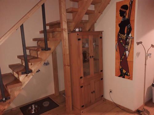 a staircase in a home with a wooden stair case at Maisonette Pablo in Gummersbach