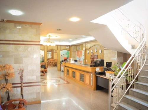 a living room with a staircase in a house at Submukda Phoomplace Hotel in Mukdahan