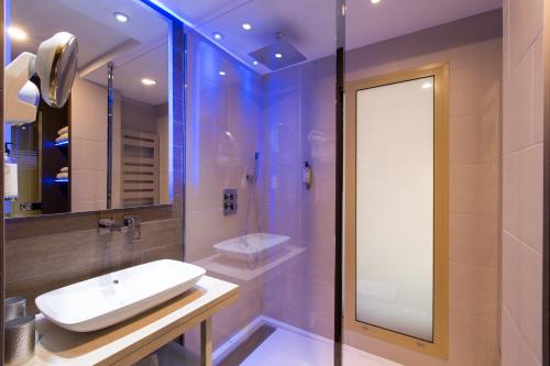 a bathroom with a white sink and a mirror at Best Western Plus La Fayette Hotel et SPA in Épinal