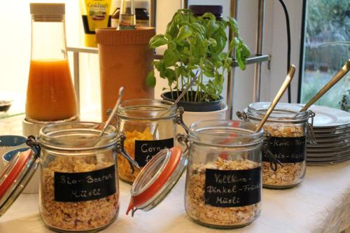four jars of food sitting on a table at Gästehaus Niemerg in Warendorf