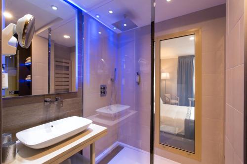 a bathroom with a sink and a shower at Best Western Plus La Fayette Hotel et SPA in Épinal