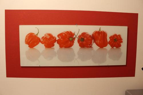 a painting of red peppers on a wall at Gästehaus Niemerg in Warendorf