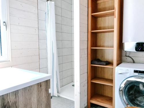 a bathroom with a washing machine and a shower at Wine & Space Lodge at Lake Balaton in Balatonlelle