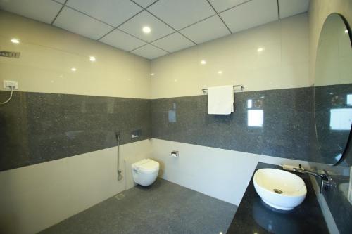 a bathroom with a toilet and a sink at Virat Resorts, Sariska Rajasthan in Bairāt