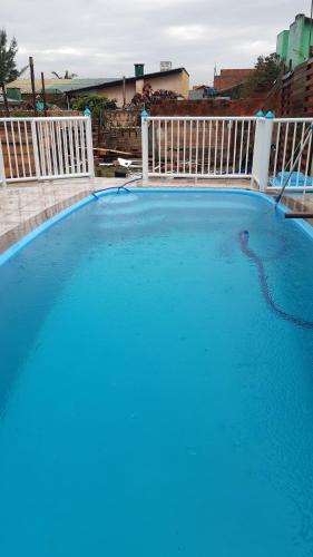 a large swimming pool with blue water at Pousada Cantinho Azul in Passo de Torres