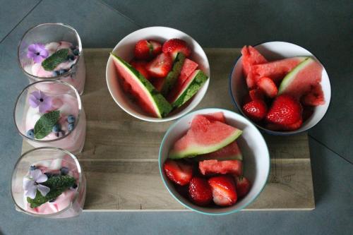 a group of bowls of strawberries and melons on a tray at Hotel Centraal in Someren